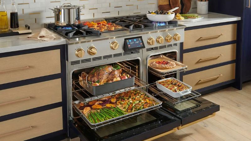 BlueStar professional-style range with open burners, griddle, and high-output features, showing the complexity of luxury cooking appliances